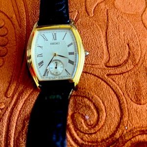 Seiko Men’s Watch. Vintage 1990’s Rectangular gold face. Black leather band.
